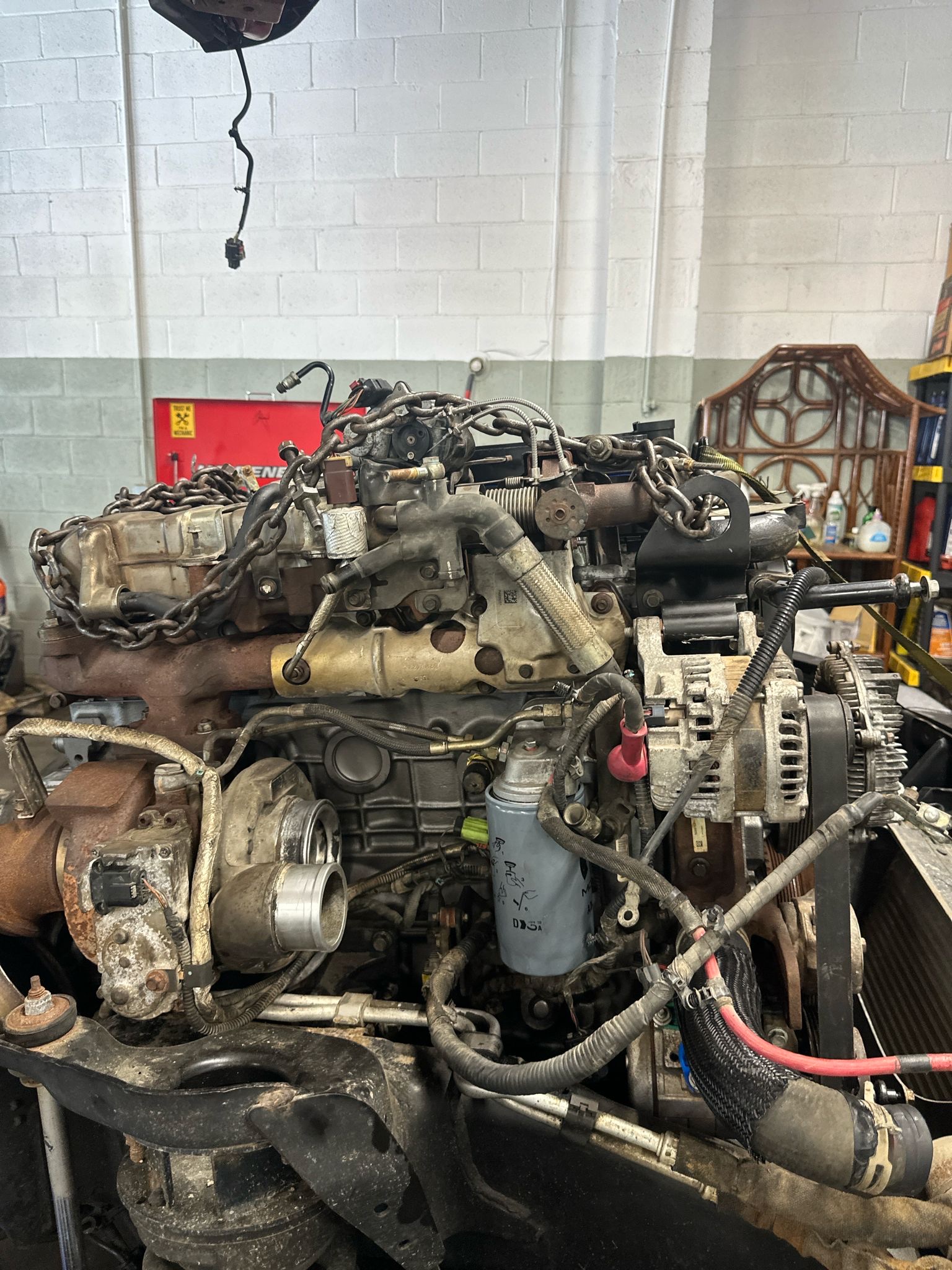 A diesel engine side view with the turbo and lifting chains